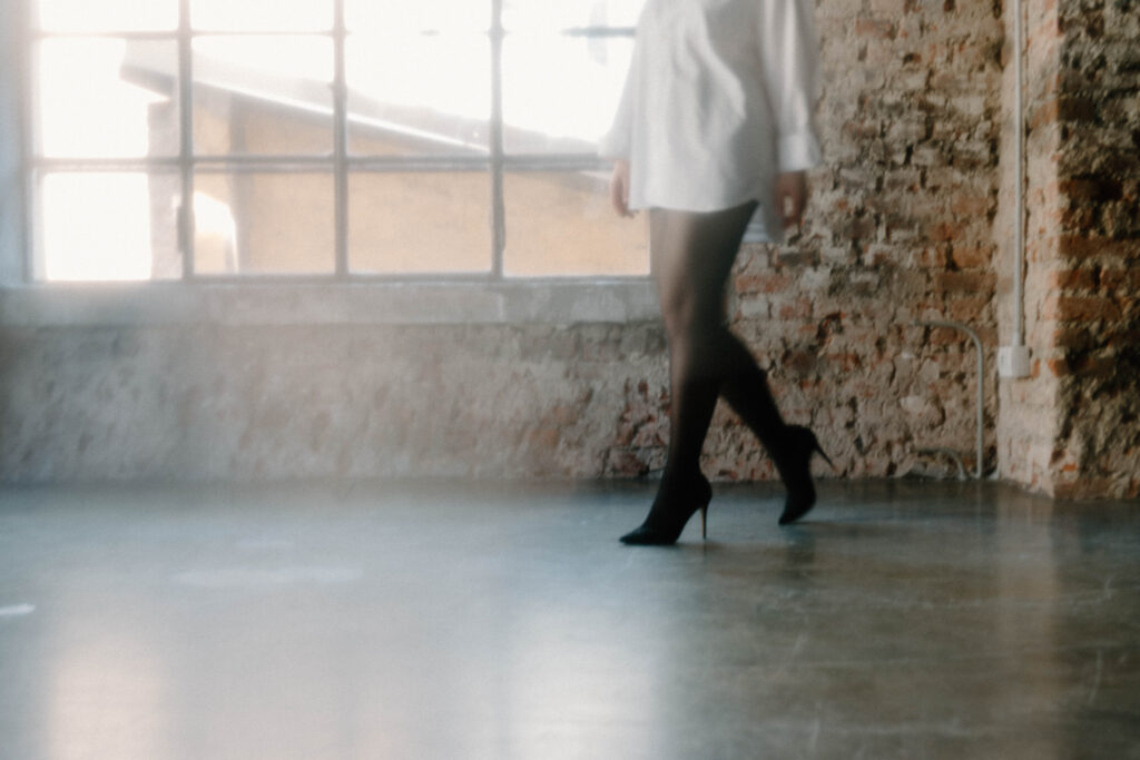 A woman's lower half is pictured and she's wearing heels and tights
